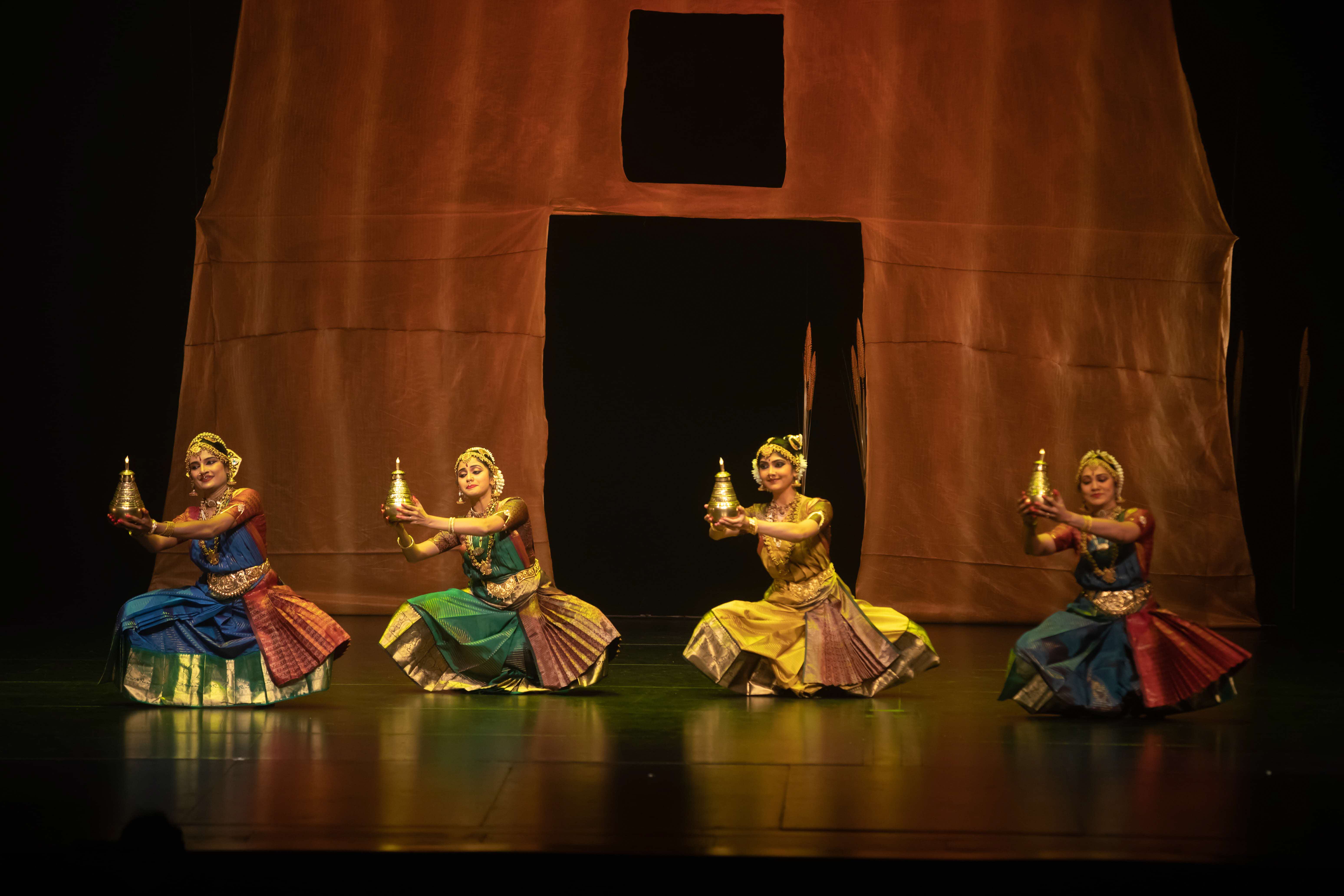 Dancers lined up in a row for 'ARISI:Rice'. Image credit: Apsaras Dance Company
